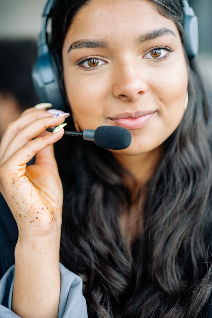 Customer-service stock photograph of a woman wearing a headset