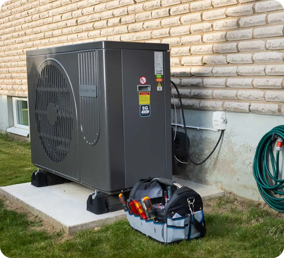 An outdoor air source heat pump with an engineer’s tool bag